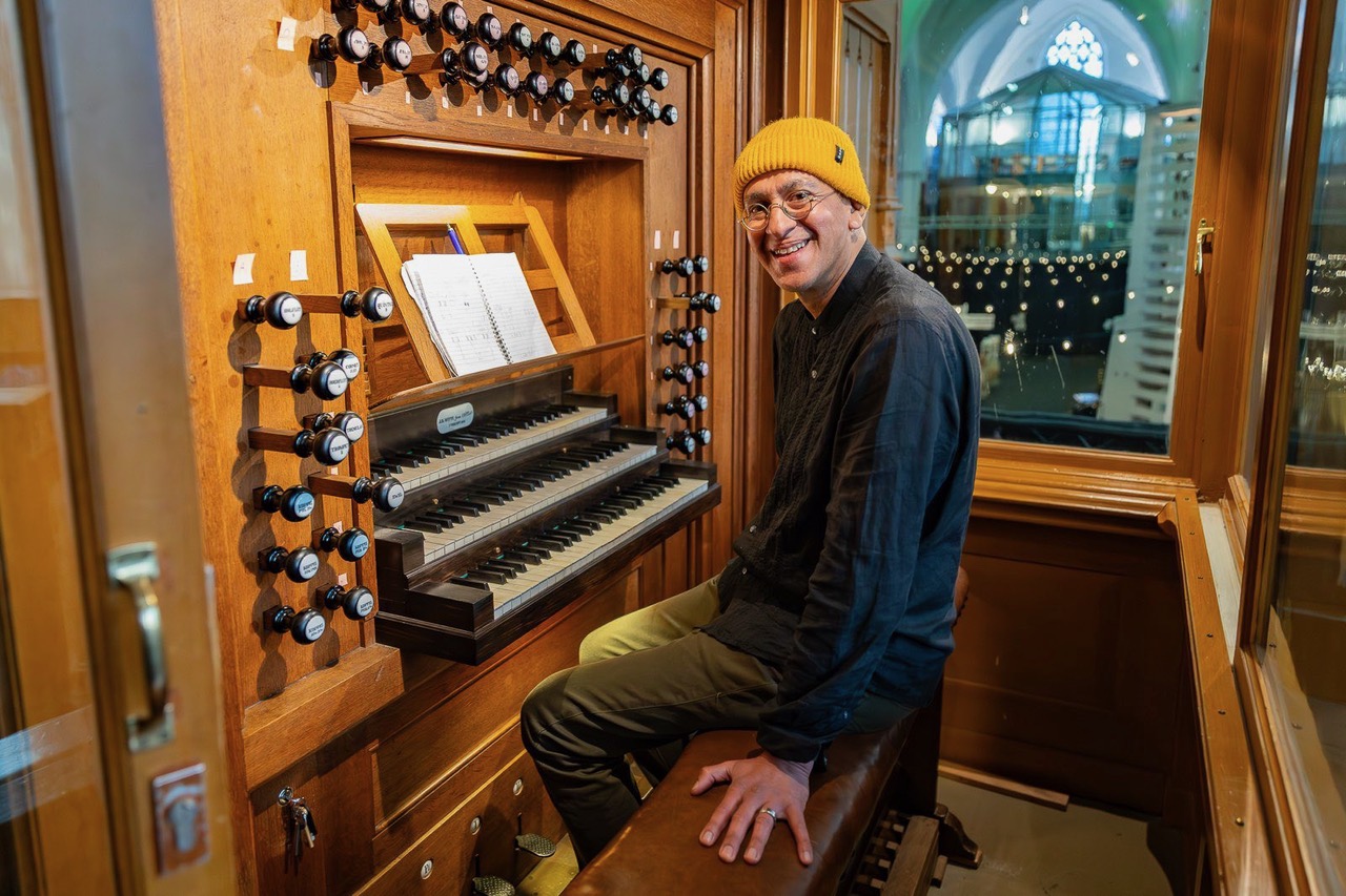 A picture of BHAJAN BHOY's Ajay Saggar seated behind the organ at Museum Speelklok during Le Guess Who? 2025